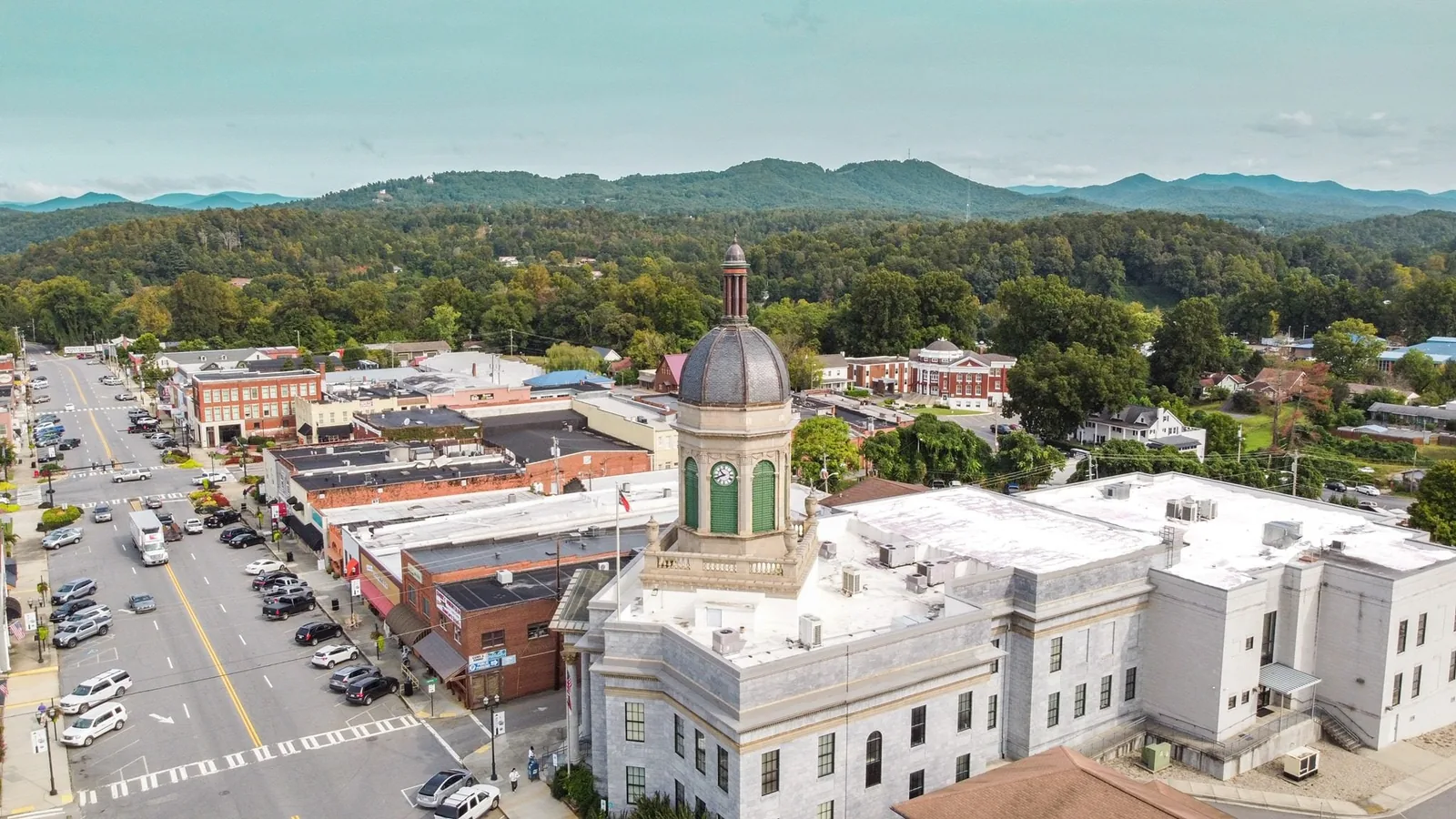 Aerial view of downtown Murphy and its domed courthouse among wooded mountains, demolition contractor service area
