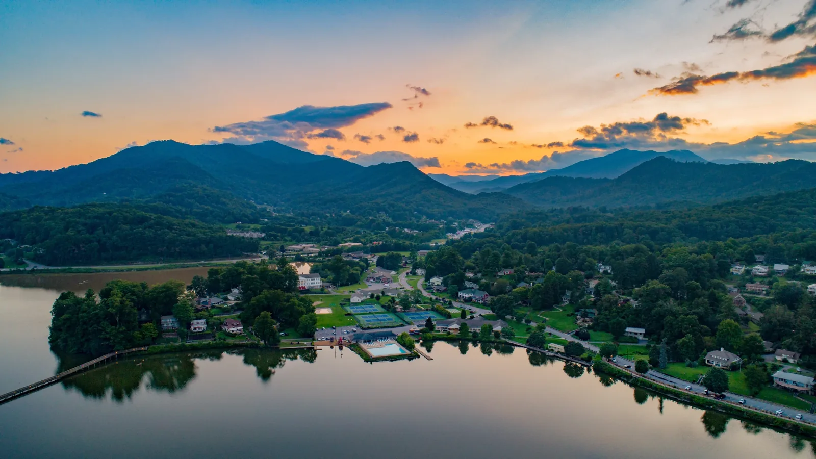 Mountain lake and wooded ridges at sunset near Brevard, demolition, land clearing and site development services